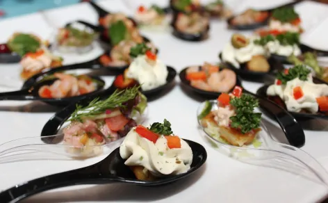 Bespoke gourmet canapés served on individual tasting spoons for a Peter Rowland cocktail catering event.